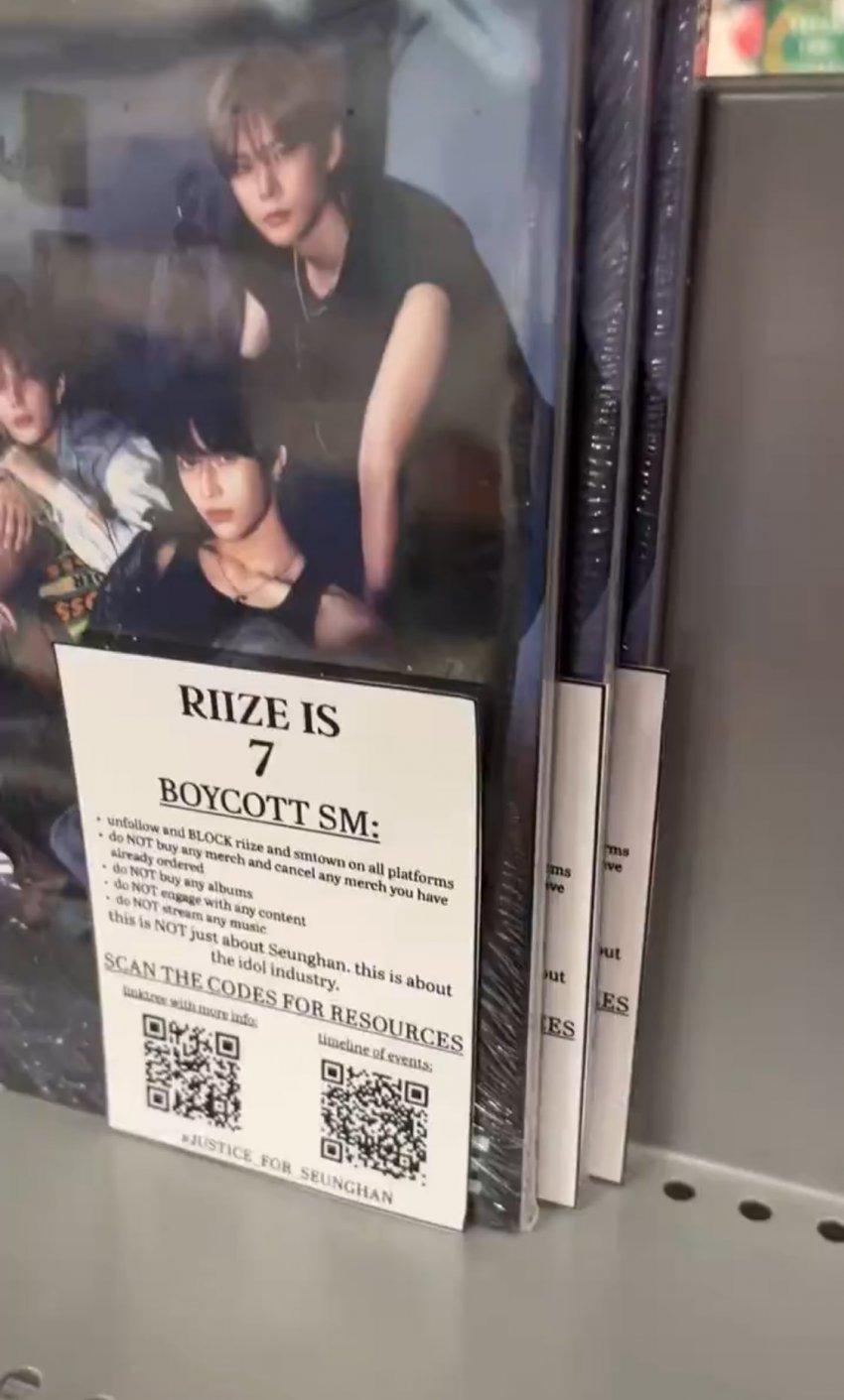 Seunghan fans are putting 'RIIZE is 7' boycott stickers on RIIZE merchandise at stores