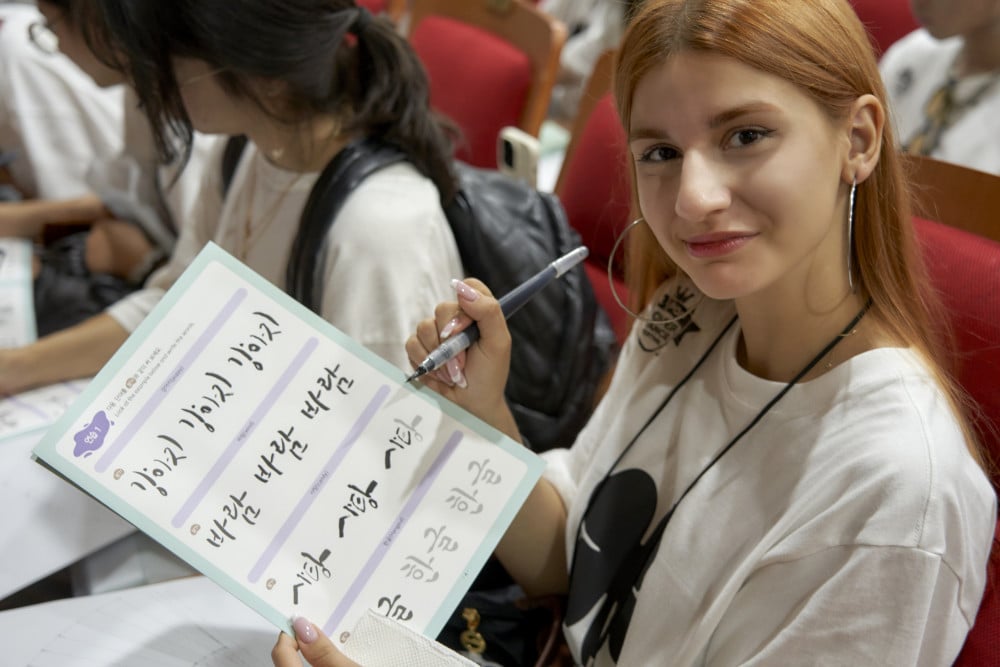 Participants writing their names in Hangeul