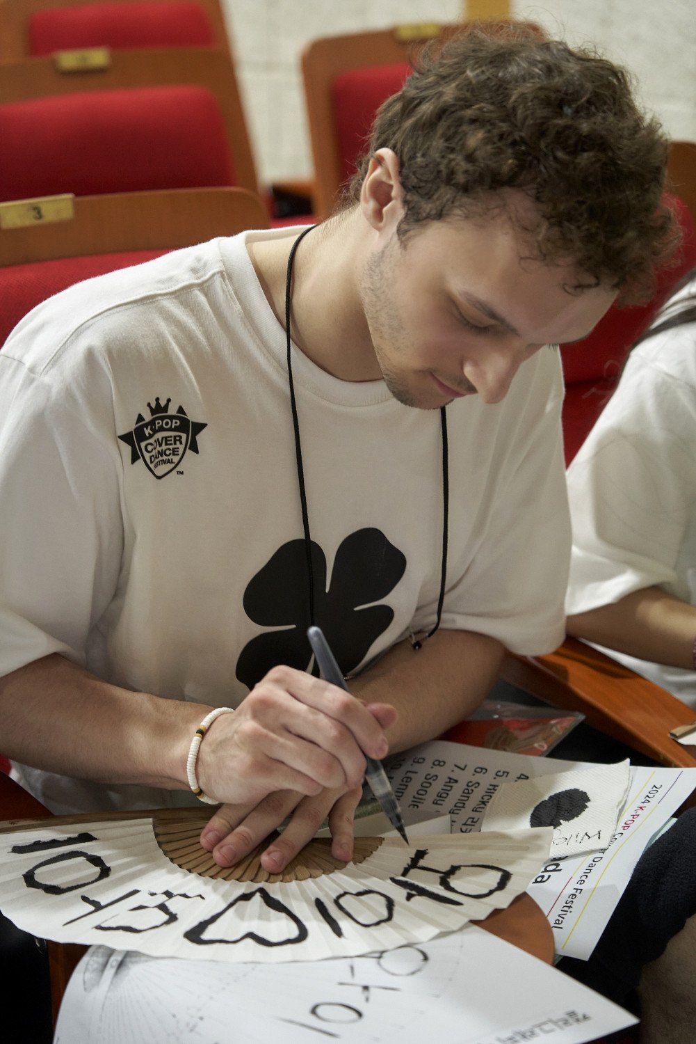 Participants displaying their Hangeul fans